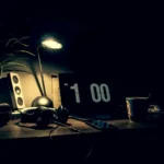 Big black digital clock on a desk at midnight